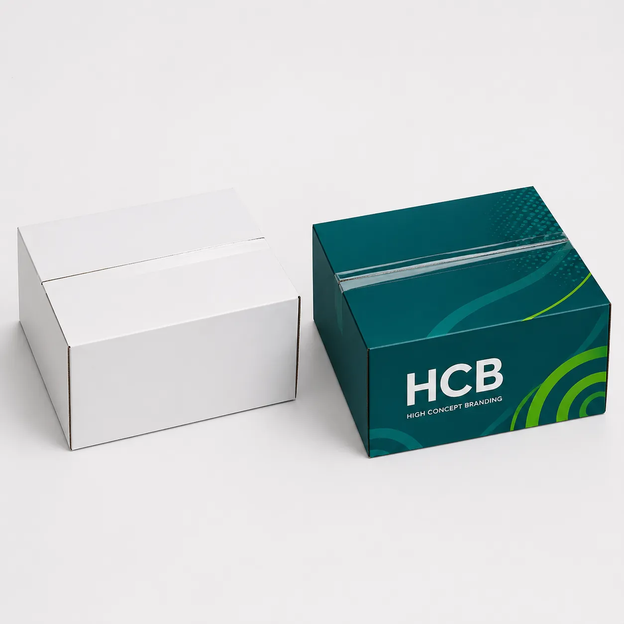 Closed corrugated shipping boxes in plain white and teal branded designs. class=